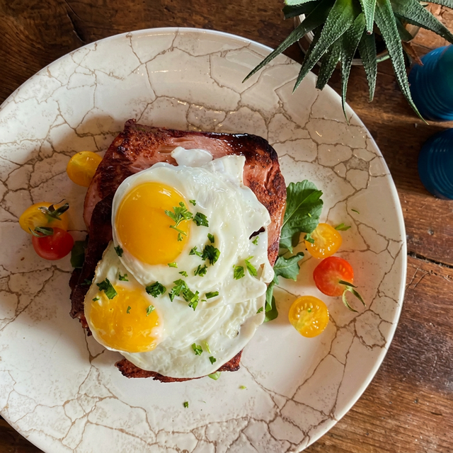 Authentic farmhouse breakfast with eggs, bacon and tomatoes